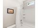 Clean white tiled shower and tub combo with a window and shower caddy at 11398 Belmont Lake Dr # 104, Las Vegas, NV 89135