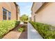 Landscaped yard featuring lush greenery and a paved walkway through the well manicured lawn at 11398 Belmont Lake Dr # 104, Las Vegas, NV 89135