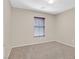 This bedroom has neutral paint and carpet and a window at 11934 Wild Chamomile St, Las Vegas, NV 89183