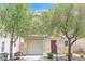 Charming single-Gathering home featuring a red front door and a one car garage at 11934 Wild Chamomile St, Las Vegas, NV 89183