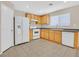 Bright kitchen featuring wood cabinets, tile flooring, and modern white appliances at 11934 Wild Chamomile St, Las Vegas, NV 89183