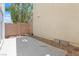 View of a concrete patio surrounded by a cinderblock fence and desert landscaping at 11934 Wild Chamomile St, Las Vegas, NV 89183