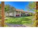 Expansive backyard features a lush lawn, covered patio, and tasteful landscaping, perfect for outdoor living at 1432 Castle Crest Dr, Las Vegas, NV 89117