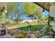 Lush backyard featuring a birdbath and mature trees, creating a peaceful outdoor retreat at 1432 Castle Crest Dr, Las Vegas, NV 89117
