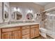 Bathroom featuring double sinks, granite counters, a glass shower, and tiled accents at 1432 Castle Crest Dr, Las Vegas, NV 89117