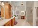Luxury bathroom with a soaking tub, glass shower enclosure, and elegant vanity at 1432 Castle Crest Dr, Las Vegas, NV 89117