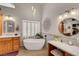 Bright bathroom with a soaking tub, vanity area, and stylish decor at 1432 Castle Crest Dr, Las Vegas, NV 89117