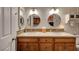 Bathroom featuring double sinks with a modern vanity and decorative mosaic backsplash at 1432 Castle Crest Dr, Las Vegas, NV 89117