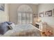 Bright bedroom with a large arched window, offering plenty of natural light and a serene atmosphere at 1432 Castle Crest Dr, Las Vegas, NV 89117