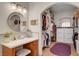Bright walk-in closet with vanity, arched entrance, and ample storage at 1432 Castle Crest Dr, Las Vegas, NV 89117