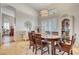 Bright dining area featuring stylish lighting, wood furniture, and plantation shutters at 1432 Castle Crest Dr, Las Vegas, NV 89117