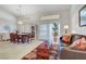Elegant dining area with stylish chandelier, plantation shutters, and an open layout at 1432 Castle Crest Dr, Las Vegas, NV 89117