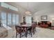 Elegant dining area with stylish lighting, plantation shutters, and an open layout perfect for entertaining at 1432 Castle Crest Dr, Las Vegas, NV 89117