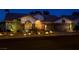 Beautiful single story home with stone accents and desert landscaping illuminated at night at 1432 Castle Crest Dr, Las Vegas, NV 89117