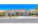Beautiful single-story home with a three car garage, brick accents and lovely desert landscaping at 1432 Castle Crest Dr, Las Vegas, NV 89117