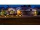 Beautiful single story home with stone accents and desert landscaping illuminated at night at 1432 Castle Crest Dr, Las Vegas, NV 89117