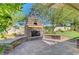 Outdoor stone fireplace and seating area, ideal for cozy evenings in the backyard at 1432 Castle Crest Dr, Las Vegas, NV 89117