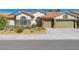 Charming single-story home with a tile roof, stucco exterior, and well-maintained desert landscaping at 1432 Castle Crest Dr, Las Vegas, NV 89117