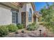 A beautiful single-story home with a tile roof, stucco exterior, and lush desert landscaping at 1432 Castle Crest Dr, Las Vegas, NV 89117