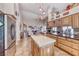 Open kitchen with stainless appliances, center island, and breakfast bar overlooking the living area at 1432 Castle Crest Dr, Las Vegas, NV 89117