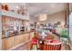 This kitchen features wooden cabinetry, a breakfast nook with a circular table, and natural light at 1432 Castle Crest Dr, Las Vegas, NV 89117