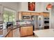 Bright kitchen featuring stainless steel appliances, granite countertops, and light wood cabinets at 1432 Castle Crest Dr, Las Vegas, NV 89117