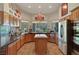 Well-appointed kitchen with stainless steel appliances and custom wood cabinetry at 1432 Castle Crest Dr, Las Vegas, NV 89117