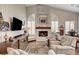 Cozy living room with stone fireplace, ceiling fan, media center and window shutters at 1432 Castle Crest Dr, Las Vegas, NV 89117