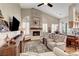 Inviting living room with stone fireplace, ceiling fan and media center, perfect for relaxation at 1432 Castle Crest Dr, Las Vegas, NV 89117