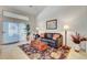 Comfortable living room showcasing a stylish rug and decor, with sliding glass doors to the outdoors at 1432 Castle Crest Dr, Las Vegas, NV 89117