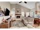 The living room features a cozy fireplace, plantation shutters, and a stylish blend of comfort and elegance at 1432 Castle Crest Dr, Las Vegas, NV 89117