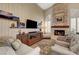 Comfortable living room showcasing a stone fireplace, tv, and plush seating at 1432 Castle Crest Dr, Las Vegas, NV 89117