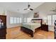 Relaxing main bedroom with a ceiling fan, hardwood floors, and plantation shutters at 1432 Castle Crest Dr, Las Vegas, NV 89117