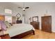 Stylish main bedroom with hardwood floors, high ceilings, and dark wood furniture at 1432 Castle Crest Dr, Las Vegas, NV 89117