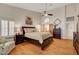 Main bedroom featuring hardwood floors, shuttered windows, and dark wood furnishings at 1432 Castle Crest Dr, Las Vegas, NV 89117
