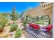 Charming covered patio featuring an outdoor fireplace and cozy seating, perfect for relaxation and entertaining at 1432 Castle Crest Dr, Las Vegas, NV 89117