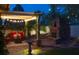 Inviting backyard patio with stone fireplace, lush greenery and ambient lighting create a relaxing outdoor atmosphere at 1432 Castle Crest Dr, Las Vegas, NV 89117
