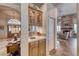 Butlers pantry boasts a sink, upper cabinets with glass doors, and mirrors at 1432 Castle Crest Dr, Las Vegas, NV 89117