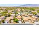 Aerial shot of the home and neighborhood with neutral-toned houses and desert landscaping at 1540 Singing Bird Ln, North Las Vegas, NV 89031