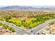 A beautiful aerial view of a neighborhood park, ball fields, and homes with mountains in the background at 1540 Singing Bird Ln, North Las Vegas, NV 89031