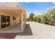 The backyard has a covered patio, gravel landscaping, and a decorative seating area with a white metal frame at 1540 Singing Bird Ln, North Las Vegas, NV 89031