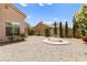 The backyard includes an outdoor seating area surrounded by rock and lovely desert landscaping at 1540 Singing Bird Ln, North Las Vegas, NV 89031