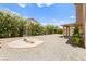 Relax in this spacious backyard with a covered patio and beautiful desert landscaping at 1540 Singing Bird Ln, North Las Vegas, NV 89031