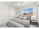 Bright staged bedroom with a ceiling fan and large window providing ample natural light at 1540 Singing Bird Ln, North Las Vegas, NV 89031