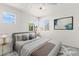 Bright staged bedroom with a ceiling fan and large windows providing ample natural light at 1540 Singing Bird Ln, North Las Vegas, NV 89031