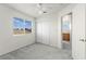 Well-lit bedroom with a ceiling fan, large window, and sliding door closet at 1540 Singing Bird Ln, North Las Vegas, NV 89031