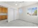 Well-lit bedroom with a ceiling fan, window, and sliding door closet and built-in storage at 1540 Singing Bird Ln, North Las Vegas, NV 89031