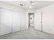 This bright bedroom features a fan, closet, and ensuite bathroom at 1540 Singing Bird Ln, North Las Vegas, NV 89031