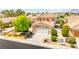 Two-story home featuring a well-manicured lawn, mature landscaping, and an attached two-car garage at 1540 Singing Bird Ln, North Las Vegas, NV 89031