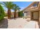Home's front yard features palm trees and a gravel landscape at 1540 Singing Bird Ln, North Las Vegas, NV 89031
